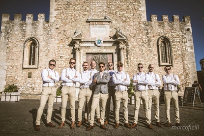 The boys line up for a photo in front of the medieval Duomo Cathedral of Taormina