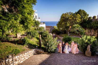 Bridal party walking up the garden pathway to the Palazzo Duchi di Santo Stefano wedding hall in Taormina