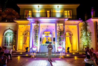 Grooms speech with a backdrop of stunning architectual lighting on the Afrodite Terrace at Belmond Grand Hotel Timeo