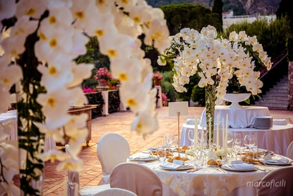 Cascading phalaenopsis orchids reception table centrepieces on the Afrodite Terrace at Belmond Grand Hotel Timeo Taormina