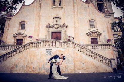 Bride and Groom kiss in front of the iconic San Giuseppe Church in the centre of Taormina
