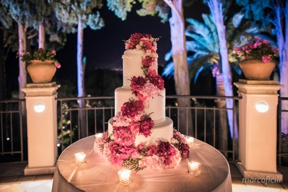 Luxury wedding cake with pink and fuscia floral cascade in Taormina
