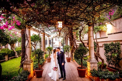 Bride and Groom arriving at their reception in the bougainville entrance of Belmond Grand Hotel Timeo Taormina